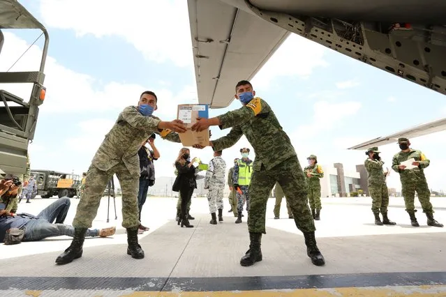 Military officers unload 5.6 tons of supplies to distribute for Insabi hospitals arrived at the Military Air Base on May 12, 2020 in Monterrey, Mexico. Non essential activities are not permitted during stage three of the nation-wide health emergency during the COVID-19 pandemic. However, no sanctions were announced and protective measures vary depending on each state. Mexico is facing the peak of contagion with COVID-19 according to Hugo Lopez-Gatell Undersecretary of Prevention and Health Promotion. Mexico City remains as the State with the higher number of cases and deceases. (Photo by Jam Media/Getty Images)