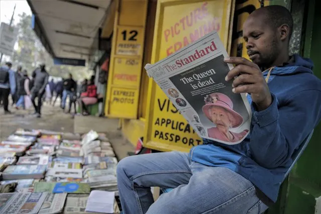 A vendor reads a newspaper showing coverage of the death of Queen Elizabeth II, in downtown Nairobi, Kenya on Friday, September 9, 2022. (Photo by Brian Inganga/AP Photo)