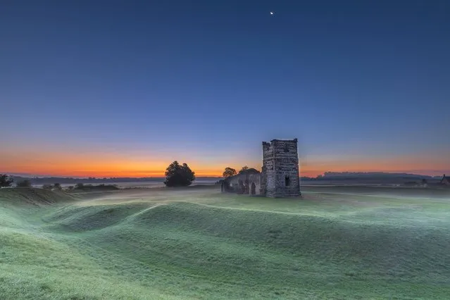 Sunrise on a chilly morning at Knowlton Church and Marden Henge in Dorset, United Kingdom on September 21, 2022. (Photo by South West News Service)