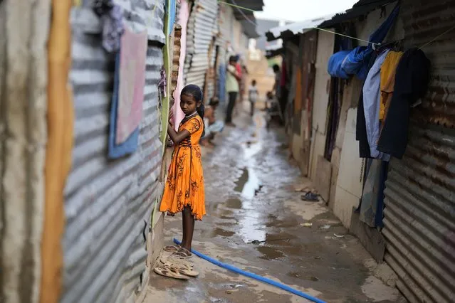 Jerifa Islam stands outside her home in a poor neighborhood in Bengaluru, India, Wednesday, July 20, 2022. A flood in 2019 in the Darrang district of India's Assam state started Jerifa Islam, her brother Raju and their parents on a journey that led the family from their Himalayan village to the poor neighborhood. (Photo by Aijaz Rahi/AP Photo)