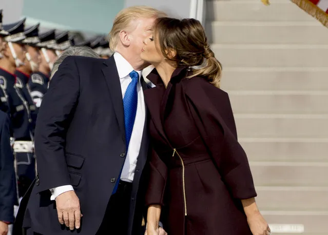President Donald Trump kisses first lady Melania Trump as they arrive at Osan Air Base in Pyeongtaek, South Korea, Tuesday, November 7, 2017. (Photo by Andrew Harnik/AP Photo)