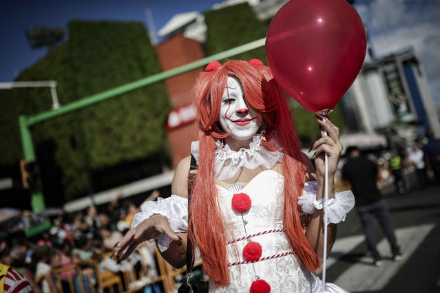 A woman takes part in a carnival parade as part of New Year's Eve festivities in San Jose, Costa Rica on December 27, 2023. (Photo by Jeffrey Arguedas/EPA/EFE)