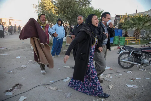People react following an earthquake in Sarpol-e Zahab county in Kermanshah, Iran, Monday, November 13, 2017. (Photo by Reuters/Tasnim News Agency)