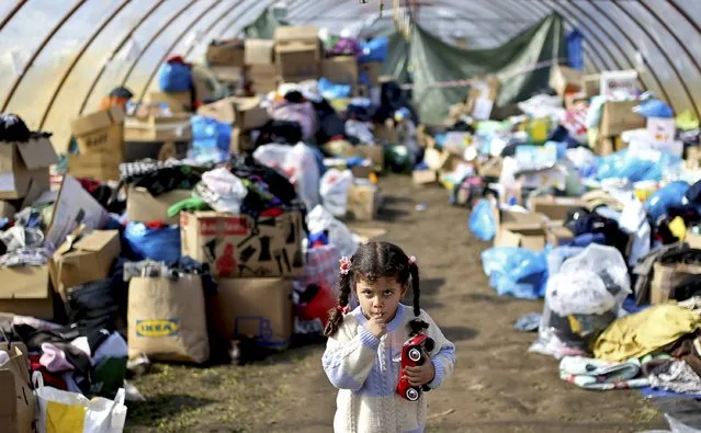 A migrant child looks on at a distribution centre with donated articles in a collection point in Roszke, Hungary September 14, 2015. (Photo by Dado Ruvic/Reuters)