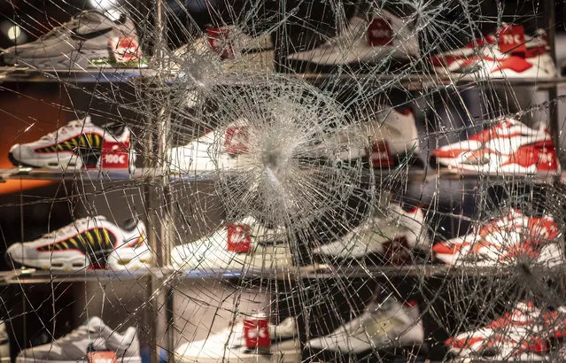 A window of a shop for shoes is destroyed at the  Koenigstrasse in Stuttgart, Germany, Sunday, June 21, 2020. Dozens of violent small groups devastated downtown Stuttgart on Sunday night and injured several police officers, German news agency DPA reported. (Photo by Christoph Schmidt/dpa via AP Photo)