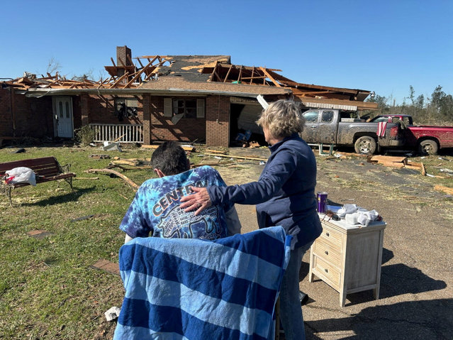 Cynthia Leake comforts Mickey Power in front of his home the day after a tornado destroyed it in Tylertown, Mississippi on March 16, 2025. (Photo by Brian Broom/USA Today Network)