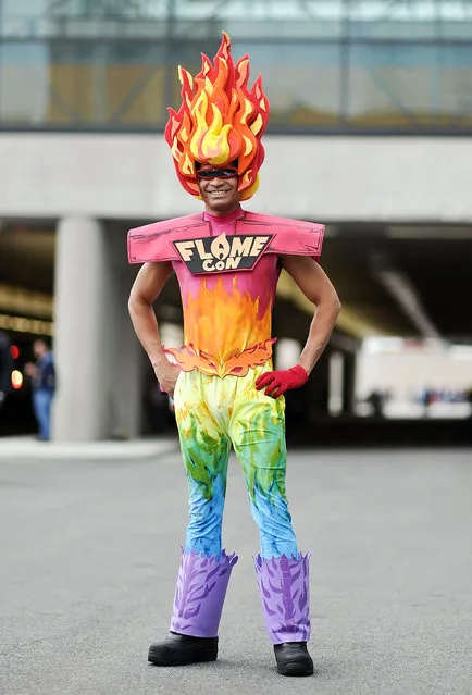 A Comic Con attendee poses as Flame during the 2014 New York Comic Con at Jacob Javitz Center on October 9, 2014 in New York City. (Photo by Daniel Zuchnik/Getty Images)