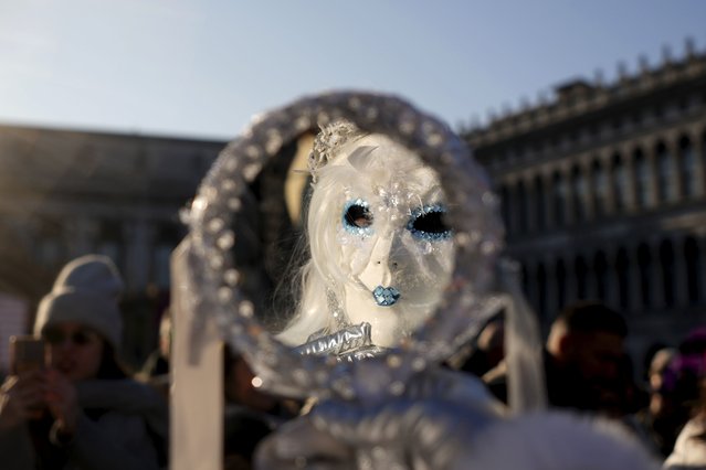 A woman wears a mask in St. Mark's square during the historical Venice Carnival, in Venice, Italy, Saturday, February 15, 2025. (Photo by Antonio Calanni/AP Photo)