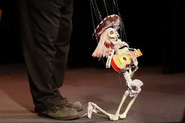 A puppeteer controls a marionette during a performance at the Bob Baker Marionette Theater in Los Angeles, California October 17, 2014. (Photo by Lucy Nicholson/Reuters)