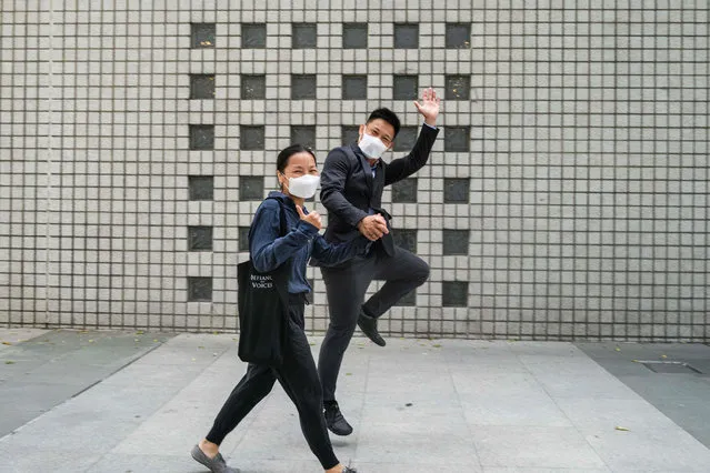 Elaine To (L), 41, and Henry Tong, 39, dance as they celebrate outside the District Court in Hong Kong on July 24, 2020, after the couple was found not guilty of rioting during last year's widespread pro-democracy protests. Tong and To were among the first batch of defendants charged with rioting since June 2019, when the massive anti-government protests rocked the financial hub. (Photo by Anthony Wallace/AFP Photo)