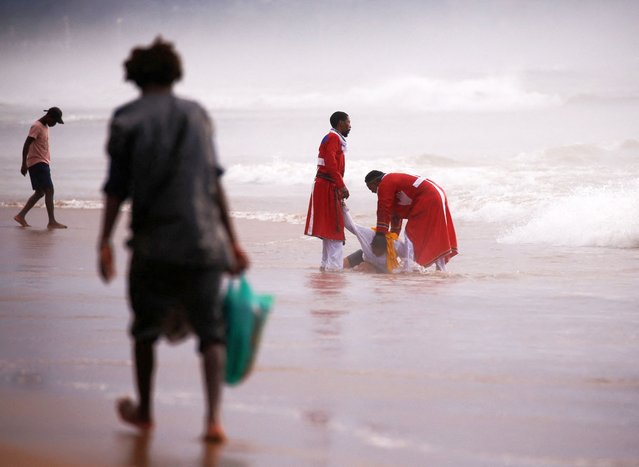 Church elders baptise a worshipper on the beach on Good Friday in Durban, South Africa, on April 18, 2025. (Photo by Rogan Ward/Reuters)