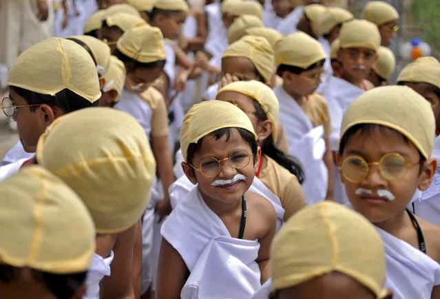 School children dressed as Mahatma Gandhi take part in an attempt to set a new Guiness World Record, for the largest gathering of people dressed as Gandhi, during celebrations to mark the 146th birth anniversary of Gandhi, in Bengaluru, India, October 2, 2015. (Photo by Abhishek N. Chinnappa/Reuters)