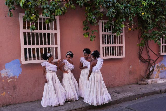 Dancers gather on a sidewalk after performing at a wedding in Cartagena, Colombia, Saturday, May 10, 2025. (Photo by Rodrigo Abd/AP Photo)