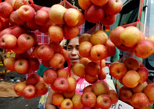 A vendor sells apples at a fruit stall ahead of New Year celebrations in Divisoria, Manila, Philippines, December 29, 2017. (Photo by Erik De Castro/Reuters)