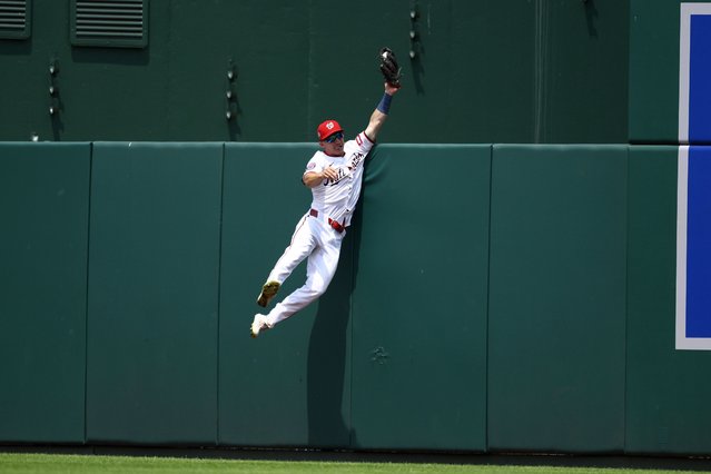 Washington Nationals center fielder Jacob Young makes a catch on a fly ball by Cincinnati Reds' Will Benson for an out during the eighth inning of a baseball game, Wednesday, July 23, 2025, in Washington. (Photo by Nick Wass/AP Photo)