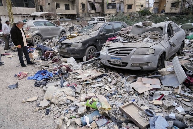 Residents inspect debris that fell onto cars parked at the site where an apartment building was struck by an Israeli targeted attack in Dahiyeh, a southern suburb of Beirut, Lebanon, early Tuesday, April 1, 2025. (Photo by Hussein Malla/AP Photo)
