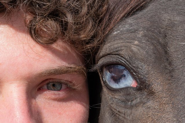 A close up of eyes of a man and a horse are seen at Cappadocia, which held a special place for horses throughout history, in Nevsehir, Turkiye on June 29, 2025. Visitors to the region can join guided horseback tours held in the wide valleys, especially during morning and evening hours. Located within the borders of Nevehir, Cappadocia stands out not only for its natural formations but also for its rich cultural heritage. (Photo by Ayten Altintas/Anadolu via Getty Images)