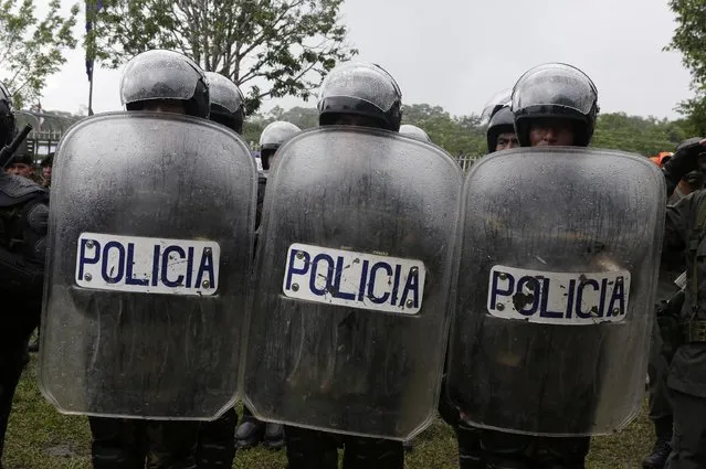 Riot policemen attend the end of their ceremony for their task of fighting against drugs and the eradication of coca leaves in Chimore, east of La Paz, December 10, 2014. (Photo by David Mercado/Reuters)