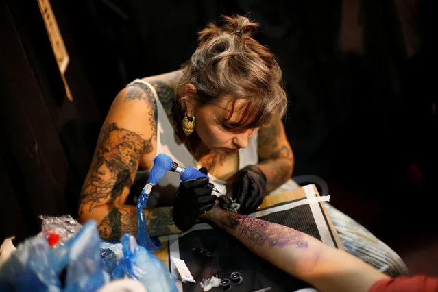 A tattoo artist works during the annual Israel Tattoo Convention in Tel Aviv, Israel, October 8, 2016. (Photo by Baz Ratner/Reuters)