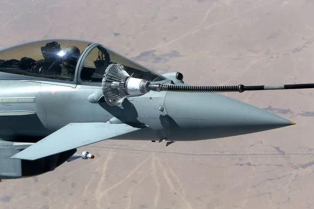In this Wednesday, September 21, 2016 photo, a Typhoon aircraft refuel from a tanker aircraft during a mission over central Iraq. British Tornado and Typhoon aircraft stationed at a U.K. air base in Cyprus are pounding Islamic State targets ahead of a major offensive by Iraqi security forces next month to recapture the key northern city of Mosul from IS militants, a senior Royal Air Force officer says. (Photo by Petros Karadjias/AP Photo)