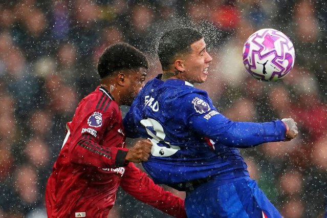 Manchester United's Amad Diallo, left, challenges for the ball with Chelsea's Enzo Fernandez during the English Premier League soccer match between Manchester United and Chelsea at the Old Trafford stadium in Manchester, England, Saturday, September 20, 2025. (Photo by Dave Thompson/AP Photo)