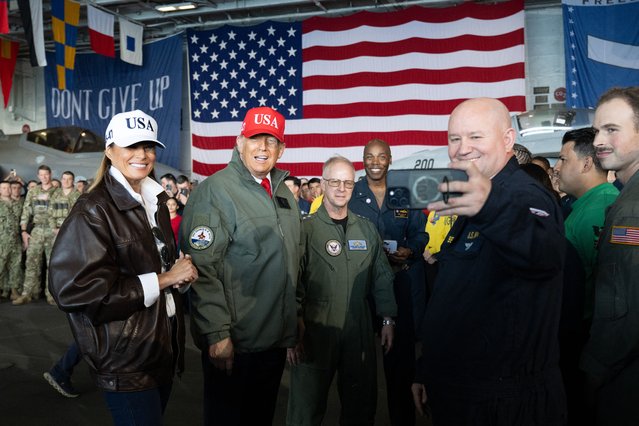 US President Donald Trump (2L) and First Lady Melania Trump (L) pose for a selfie as they greet sailors during a visit to the USS George H.W. Bush aircraft carrier which is out at sea near Norfolk, Virginia, October 5, 2025, as part of the US Navy's 250th anniversary celebration, “America's Navy 250: Titans of the Sea – A Salute to the Fleet”. (Photo by Saul Loeb/AFP Photo)