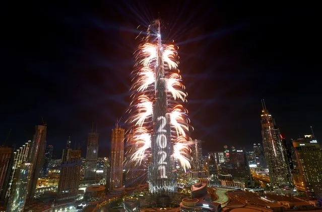 Fireworks explode from the Burj Khalifa, the tallest building in the world, during New Year's Eve celebrations in Dubai, United Arab Emirates, December 31, 2020. (Photo by Ahmed Jadallah/Reuters)