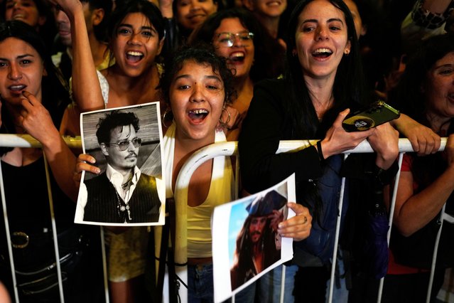 Fans of American director Johnny Depp cheer him on outside a cinema as he presents his film “Modi, Three Days on the Wing of Madness” in Buenos Aires, Argentina, November 11, 2025. (Photo by Natacha Pisarenko/AP Photo)