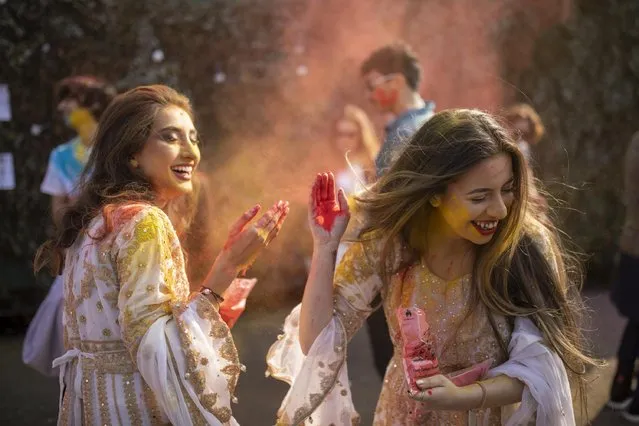 Colour flies at the Leeds Holi Festival in United Kingdom on March 19, 2022, the first event of its kind in the city, which attracted over 1,000 revellers. (Photo by James Glossop/The Times)