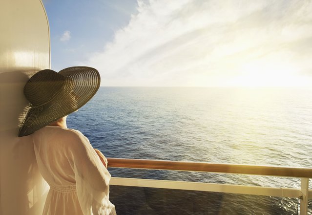Woman looking out to sea on a cruise ship. (Photo by Buena Vista Images/Getty Images)