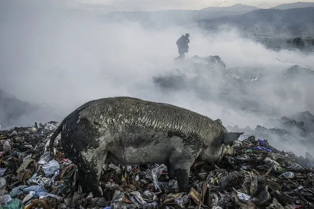 In a 200-acre-plus dump 5 kilometers north of Haiti’s capital, Port-au-Prince, hundreds of men, women and children scavenge day and night through the burning wasteland. They earn $12 to $15 a day – on a good day – for recycling plastics as well as clothing, household items and aluminum (for smelting). Some 5,000 tons of waste is created each day in the Port-au-Prince area. (Photo and caption by Giles Clarke/Getty Images Reportage)