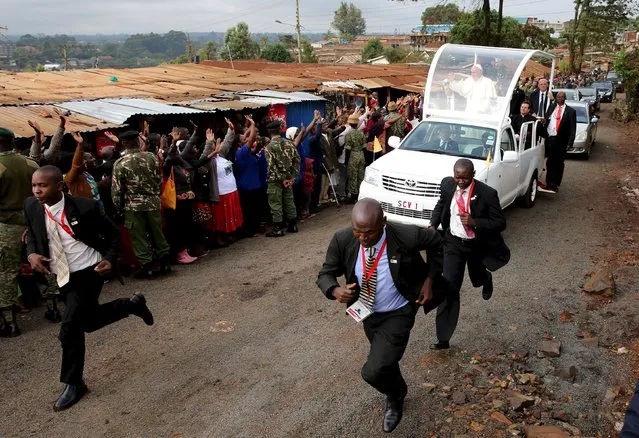 Pope Francis waves as he arrives at the Kangemi slums on the outskirts of Kenya's capital Nairobi, November 27, 2015. (Photo by Goran Tomasevic/Reuters)