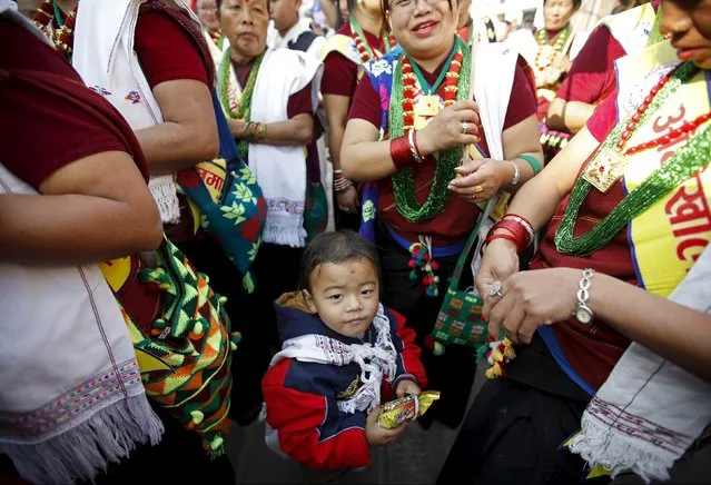 Gurung women wearing traditional costumes surround a child as they take part in a New Year parade in Kathmandu, Nepal December 30, 2015. (Photo by Navesh Chitrakar/Reuters)