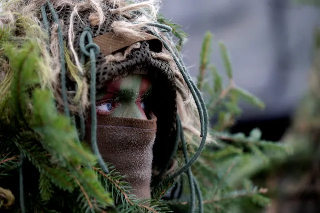Lithuanian army soldier with the other troops from 11 NATO nations takes part in the exercise in urban warfare during Iron Sword exercise in the mock town near Pabrade, Lithuania, December 2, 2016. (Photo by Ints Kalnins/Reuters)