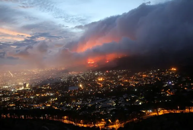 Flames are seen close to the city fanned by strong winds after a bushfire broke out on the slopes of Table Mountain in Cape Town, South Africa, April 19, 2021. (Photo by Mike Hutchings/Reuters)