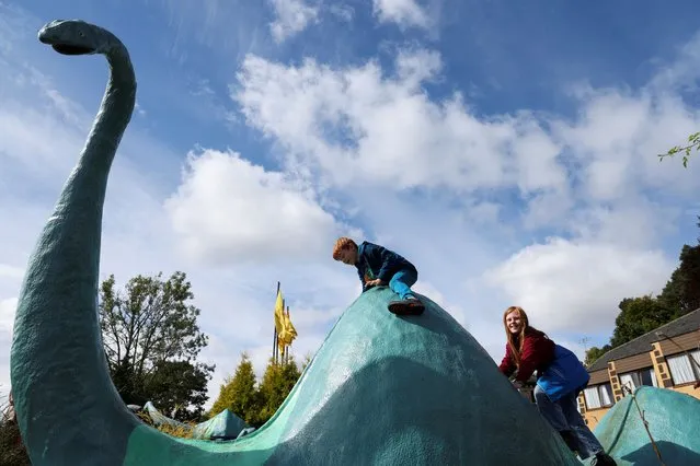 Children play on a model of Loch Ness Monster at Drumnadrochit as people take part in the largest Loch Ness Monster hunt for 50 years in Scotland, Britain on August 27, 2023. (Photo by Russell Cheyne/Reuters)