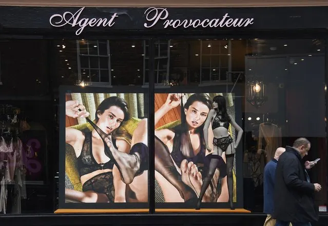 Men walk past a branch of the upmarket lingerie brand, Agent Provocateur in London, Britain, February 21, 2017. (Photo by Toby Melville/Reuters)