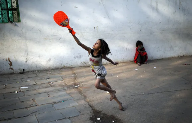A child plays with a plastic badminton racket in the old quarters of Delhi, March 3, 2016. (Photo by Anindito Mukherjee/Reuters)