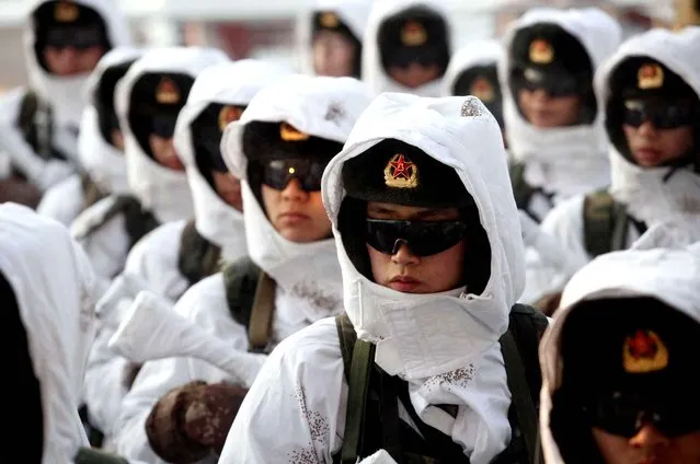 In this Wednesday, January 20, 2016 photo, Chinese People's Liberation Army (PLA) soldiers line up during a winter training drill in Heihe in northeastern China's Heilongjiang province. China’s armed forces have shut down newspapers published by the country’s seven military regions as part of a program to downsize and streamline the world’s largest standing military. (Photo by Chinatopix via AP Photo)