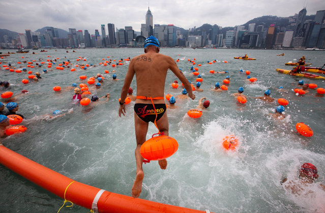 Competitors take part in the annual Hong Kong Cross Harbour Swim in Tsim Sha Tsui, Kowloon, Hong Kong, China, 21 October 2018. Around 3,600 participants swam from the Tsim Sha Tsui public pier in Kowloon to the Golden Bauhinia Square public pier in Wan Chai on Hong Kong Island. (Photo by Alex Hofford/EPA/EFE)