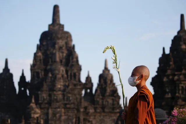 A Buddhist monk wearing a protective mask walks around the Sewu temple during the celebrations of Vesak Day, marking the birth, enlightenment and death of Buddha, amid the coronavirus disease (COVID-19) pandemic in Sleman, Yogyakarta, Indonesia, May 26, 2021. (Photo by Willy Kurniawan/Reuters)