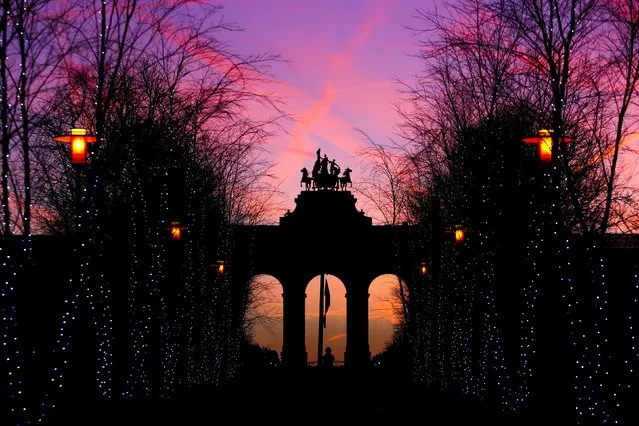 The sun rises behind the Cinquantenaire arch, erected in 1905 to replace a temporary monument built to commemorate the fiftieth anniversary of Belgian independence, in Brussels, Belgium, January 18, 2016. (Photo by Yves Herman/Reuters)