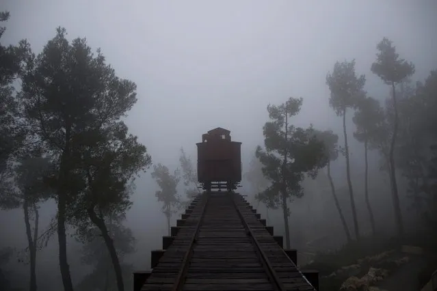 A German train box car that was used to transport Jews to concentration camps during World War II is seen on a foggy day at the Yad Vashem Holocaust Memorial Museum in Jerusalem, Israel,  26 January 2016. The International Holocaust Remembrance Day is marked annually on 27 January. (Photo by Abir Sultan/EPA)