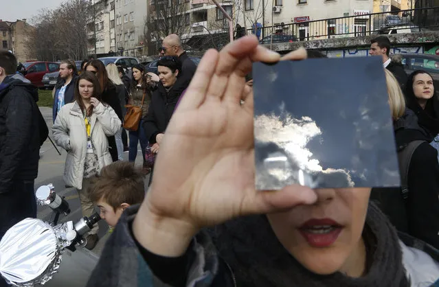 A solar eclipse is seen through a dark glass plate in Sarajevo, Bosnia, on Friday , March 20, 2015. Solar eclipse is darkening parts of Europe on Friday in a rare solar event that won't be repeated for more than a decade. (Photo by Amel Emric/AP Photo)