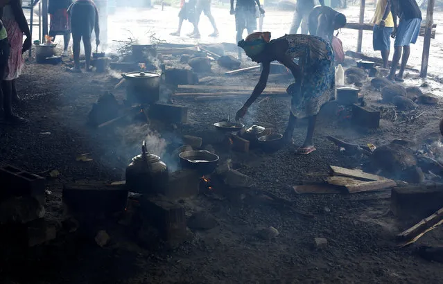 A Haitian migrants stranded in Costa Rica cooks in a makeshift camp at the border between Costa Rica and Nicaragua, in La Cruz, Costa Rica, December 20, 2016. (Photo by Juan Carlos Ulate/Reuters)