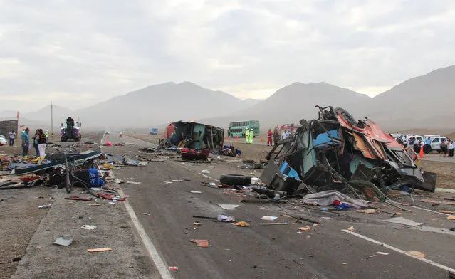 The rubble of crashed vehicles litters a coastal highway in Huarmey, Peru, Monday, March 23, 2015. Monday's pre-dawn crash involving buses and a truck killed dozens of people and injured dozens more. Police say a bus strayed into the oncoming lane and slammed head-on into the first of two other buses. A truck then plowed into the wreckage. (Photo by Magali Estrada/AP Photo)