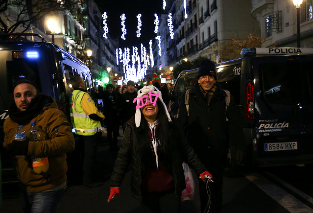 Revellers head for the start of New Year's celebrations after going through a security check at Puerta del Sol square in central Madrid, Spain December 31, 2016. (Photo by Susana Vera/Reuters)