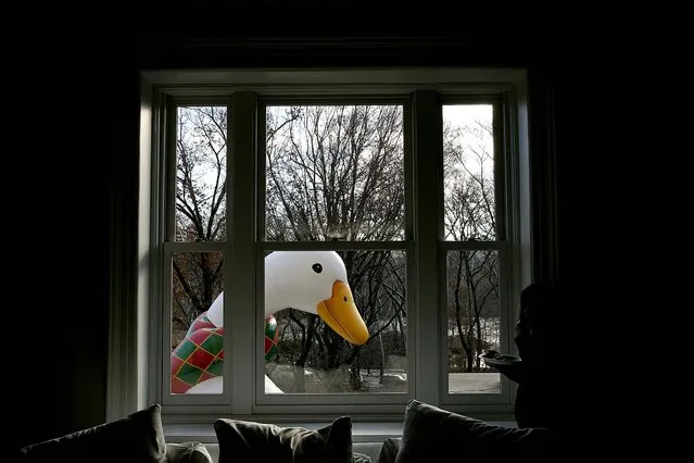 A balloon passes by the window of a third-floor apartment on Central Park West. (Photo by Todd Heisler/The New York Times)