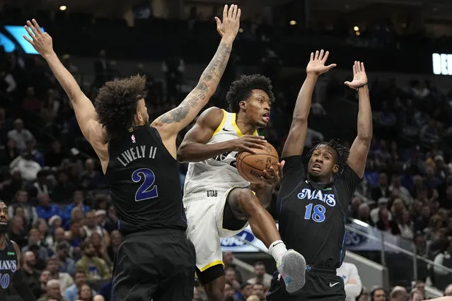Utah Jazz guard Collin Sexton (2) tries to get past Dallas Mavericks defenders Olivier-Maxence Prosper (18) and Dereck Lively II (2) during the first half of an NBA basketball game in Dallas, Wednesday, December 6, 2023. (Photo by L.M. Otero/AP Photo)