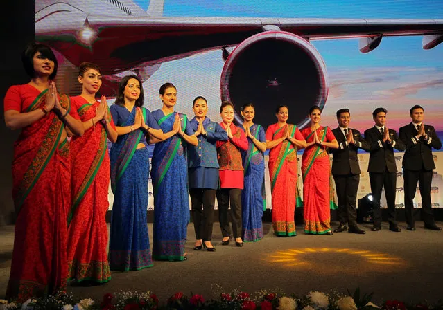 Air India stewards pose during the unveiling of their new uniforms at an aviation conference in Mumbai, January 15, 2019. (Photo by Francis Mascarenhas/Reuters)